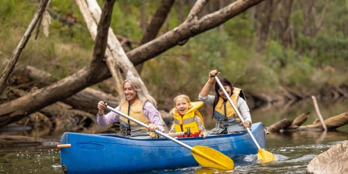 People exploring the river by kayak