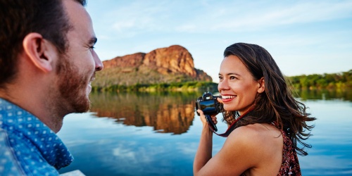 A man and a woman on a boat with a camera