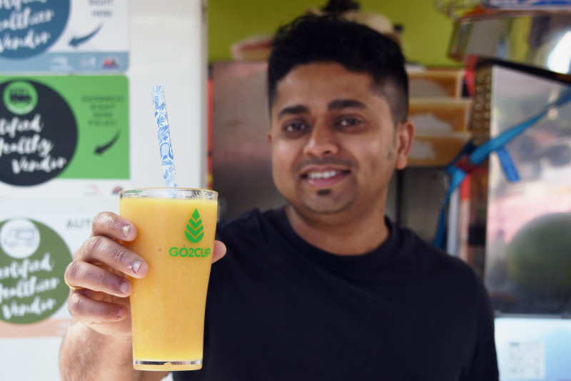 Mobile vendor serves juice in a reusable cup