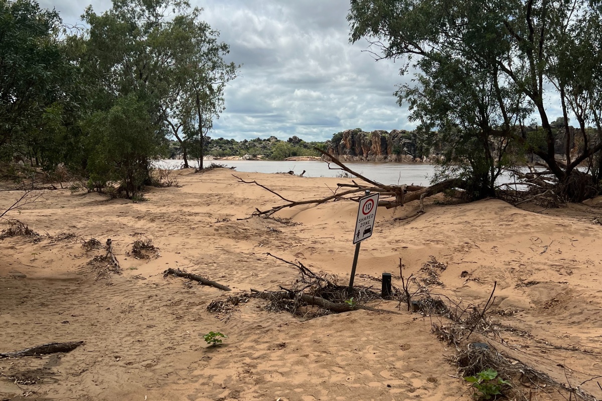 Sign in carpark depicting height of silt from flood waters