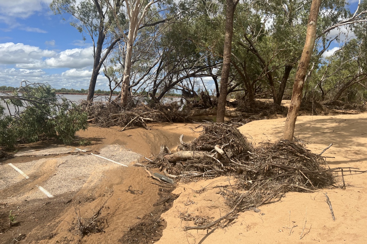 Car park covered by sediment and debris from rising flood water