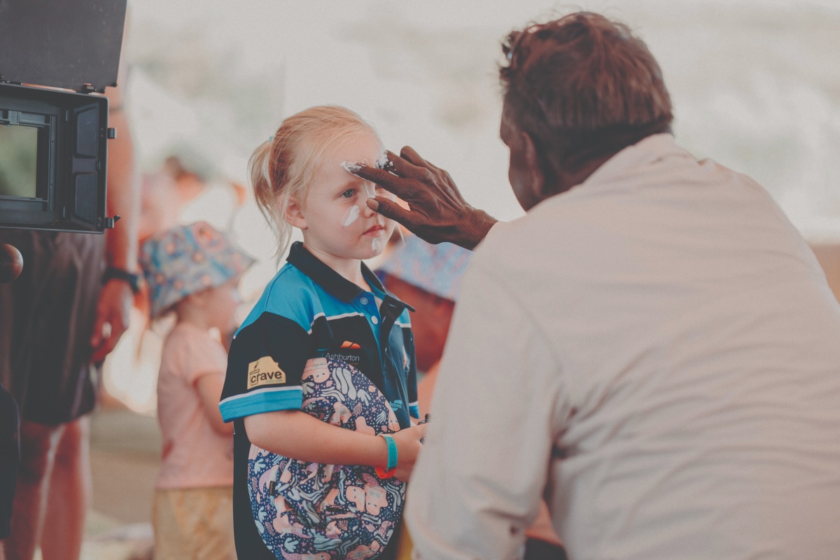 Sharing traditional face painting techniques as part of the Banjima experience. Photo – CMS Events