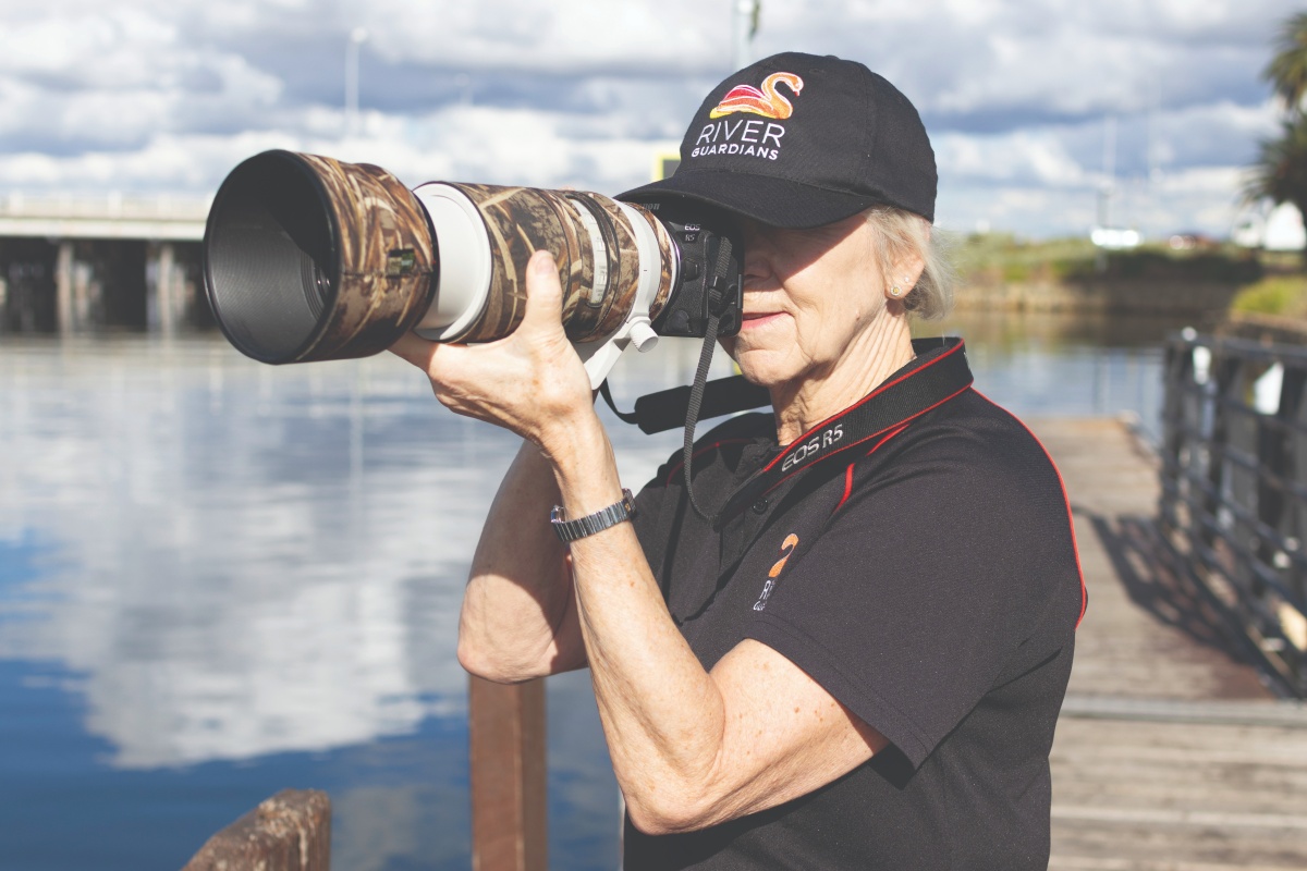 Sue taking photos to capture dolphin fin identities and data, to assist the Dolphin Watch project. Photo – Alan Gill/DBCA.