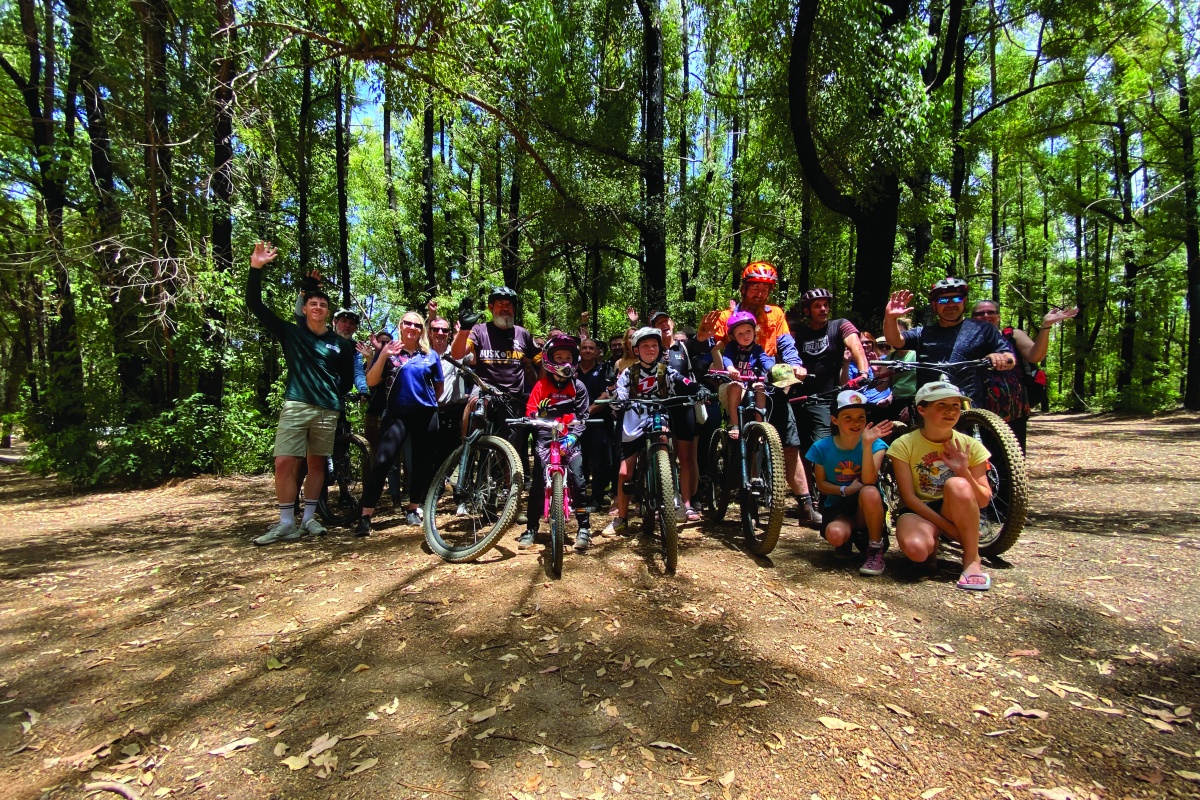 A group or riders standing in the bush Celebrating the opening of new trails. Photo – Peter Nicholas/DBCA.  