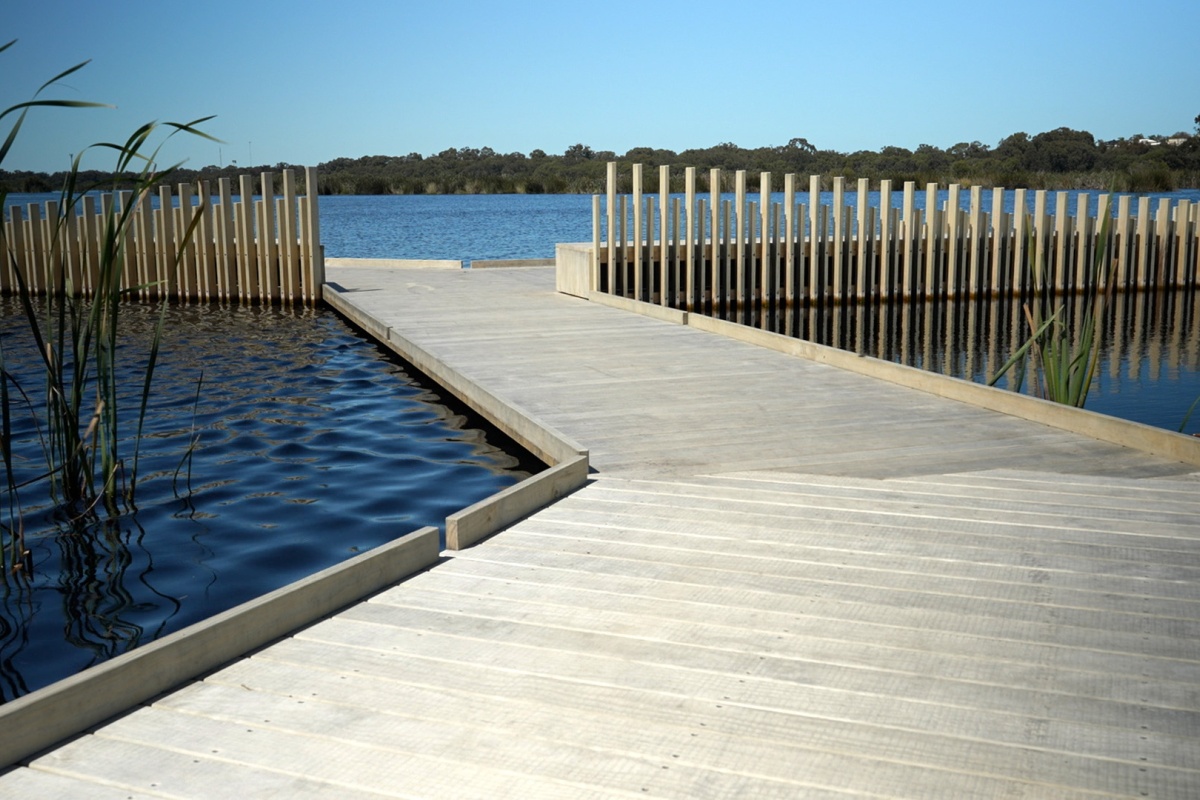 The boardwalk on the water with its vertical bars mimicking the reeds