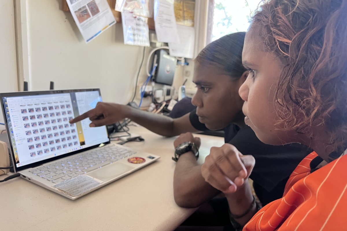 Rangers examine their photos back at the office on the computer