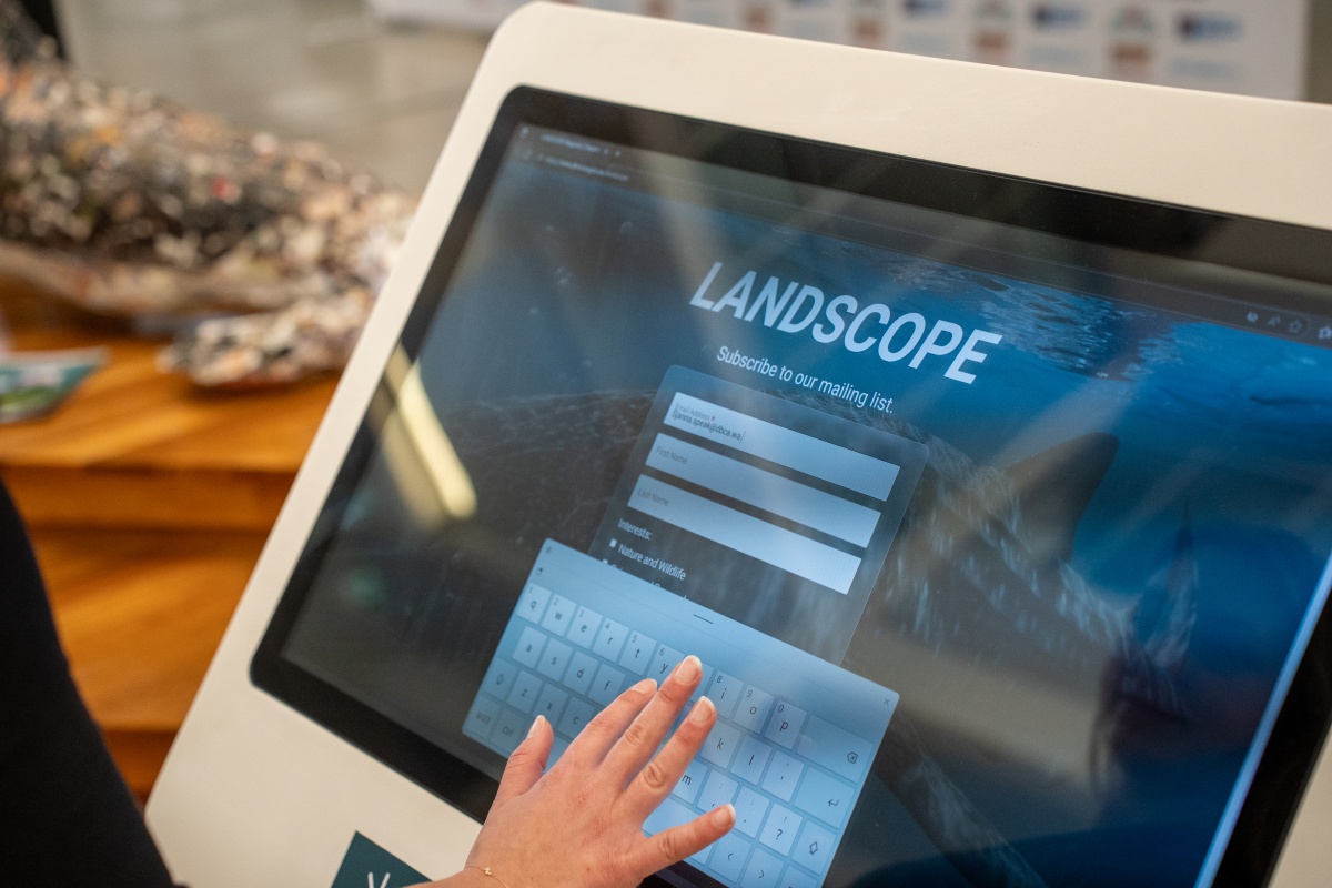 Someone touching a digital screen at the event