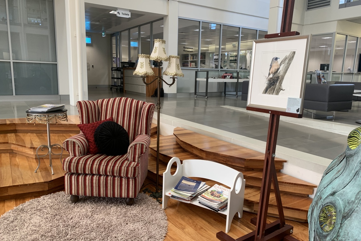 An armchair, book stand and photo frame in an exhibit