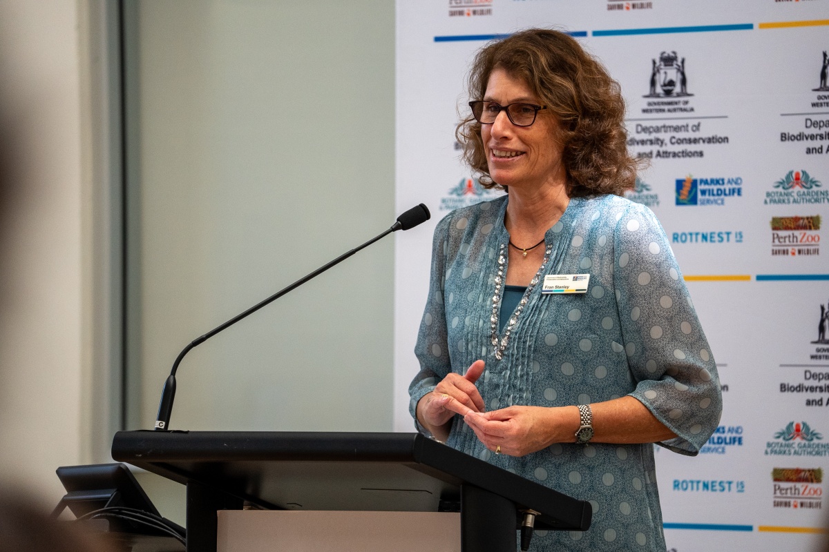 A woman gives a speech at a podium