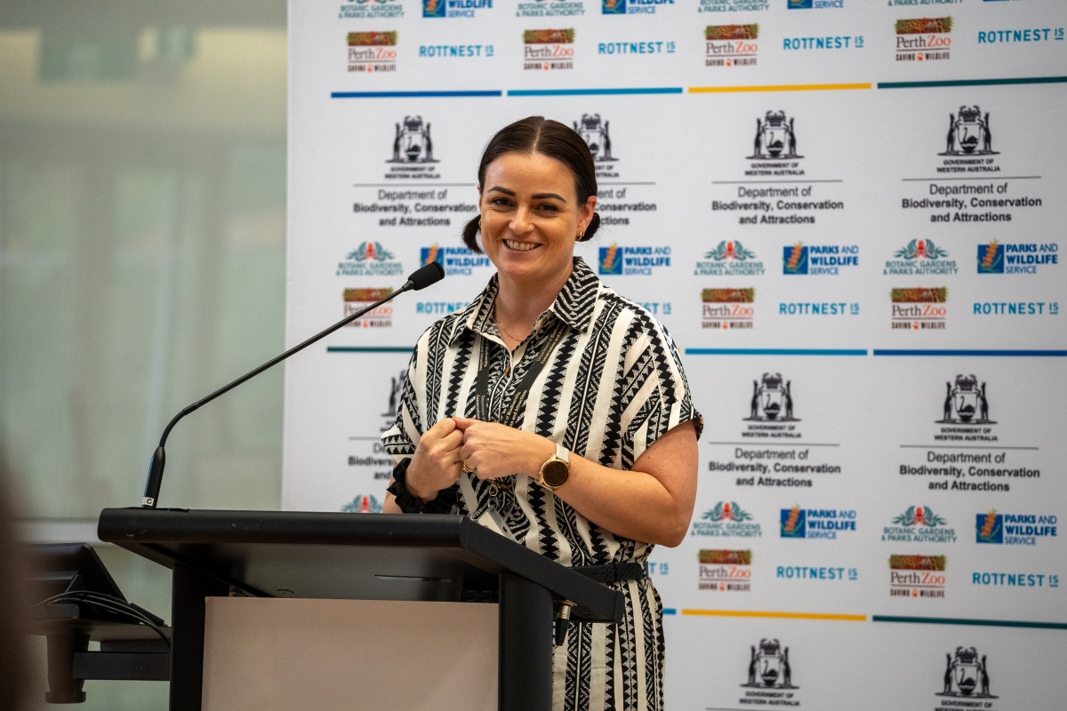 A woman gives a speech at a podium